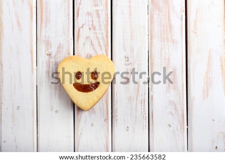 Biscuit with jam, shaped as heart with face