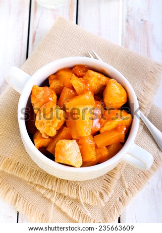 Sour and sweet chicken breast with pineapple in tomato sauce
