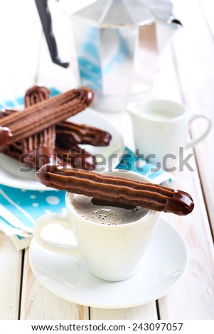 Chocolate Viennese fingers biscuits with chocolate glaze on tops and coffee