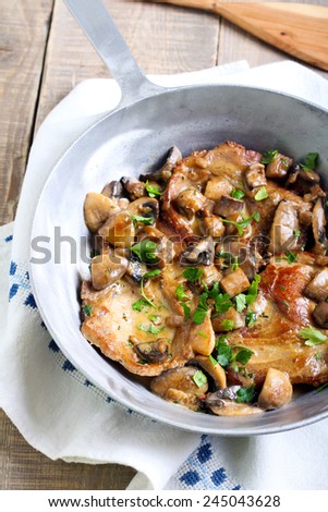 Pork chops in mushroom marsala sauce in pan