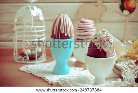 Homemade easter chocolate eggs with glaze and sprinkles, tanned