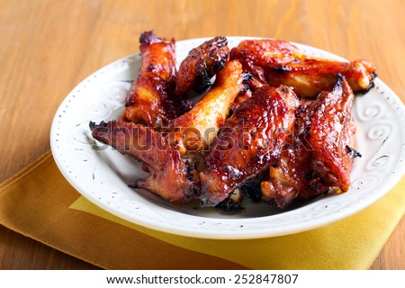 Sweet and sticky chicken wings in a bowl