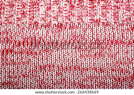 Red and white knitted wool texture pattern