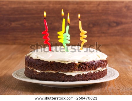 Hummingbird cake decorated as birthday cake with cream frosting and candles