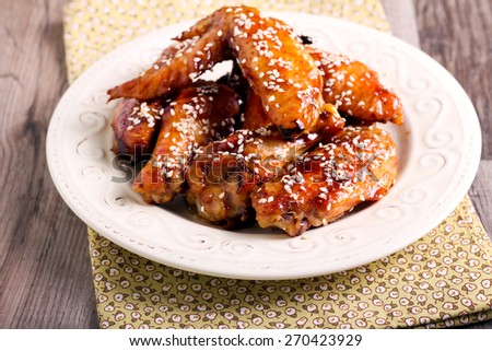 sticky sesame chicken wings in a plate