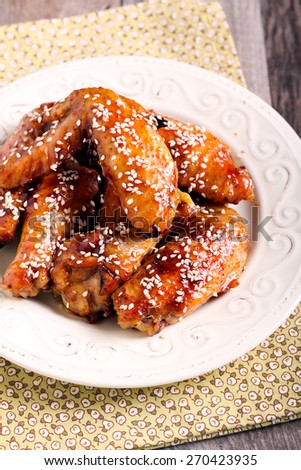 sticky sesame chicken wings in a plate