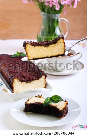 Cheesecake with chocolate topping on a cake spatula