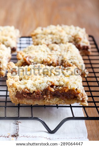 Chocolate and caramel oat bars on rack