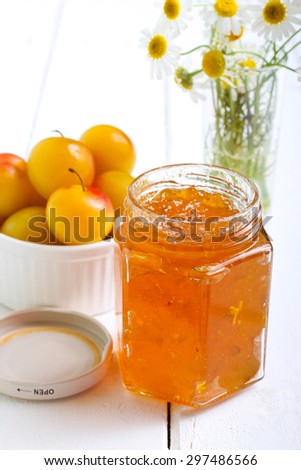Yellow plum marmalade in a jar, selective focus