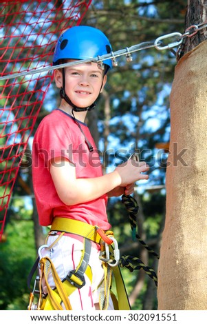 Boy in rope attraction park