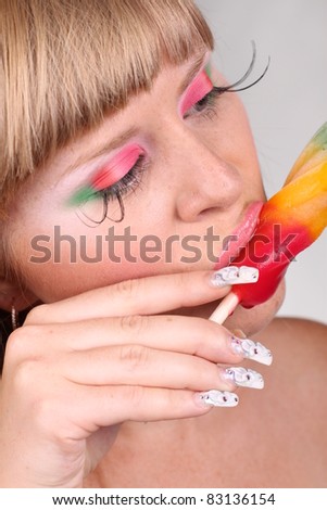 Close-up portrait of sexy caucasian young woman with glamour makeup and color ice cream