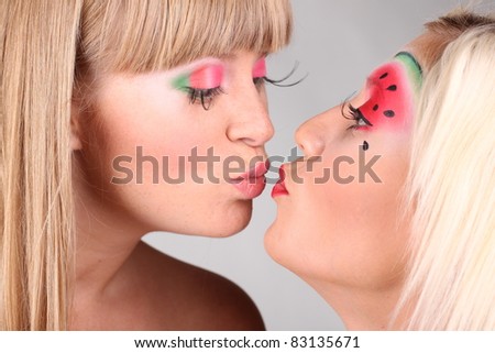 Two young pretty women kissing