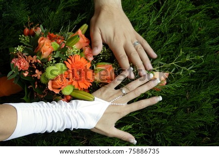 hands with a wedding bouquet