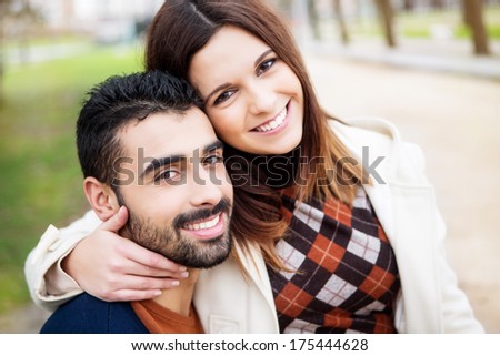 Young romantic couple on a bench in park