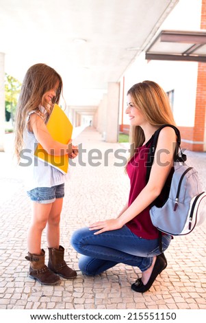 Mother saying goodbye to her daughter at school