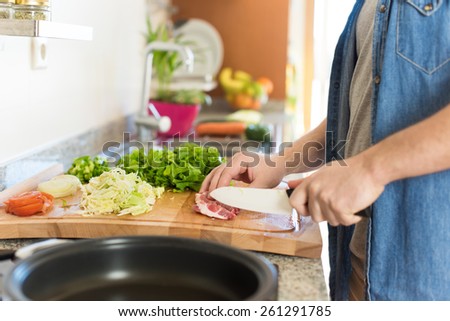Detail of man in kitchen cooking healthy lunch