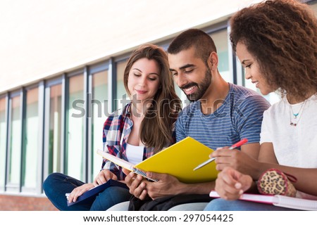 Students sharing notes in the university campus
