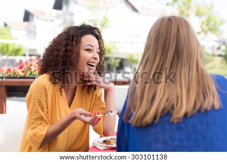 Multi-Ethnic friends talking and having fun at bar\'s balcony