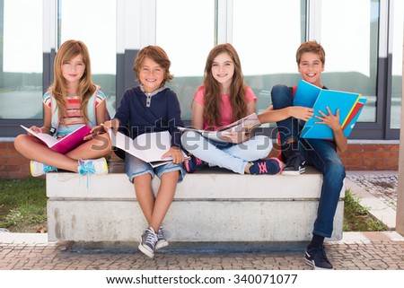 Group of happy little school kids in school