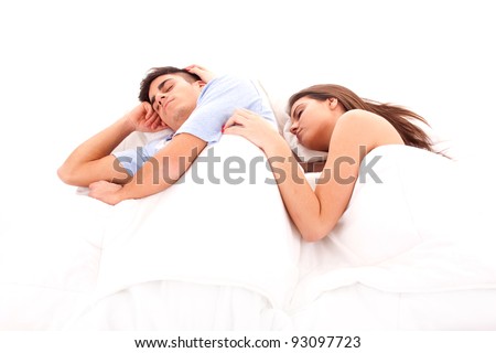 Young beautiful couple sleeping together in bed