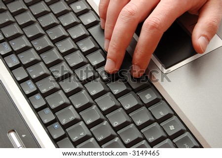 Hand on laptop
