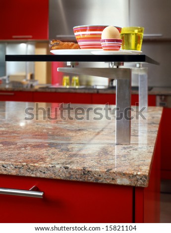 closeup of modern kitchen with red cupboard