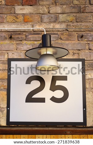 Nr 25 sign on building with porch light