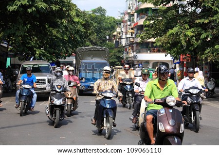 HANOI - JULY 20: Unidentified riders ride motorbikes on busy road on July 20, 2012 in Hanoi, Vietnam. Motorbike is the most favorite vehicle for Hanoians, so Hanoi is always called the motorbike city.