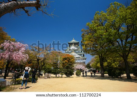 OSAKA-APR 13: Main entrance with cherry blossom at Osaka castle on April 13, 2011 in Osaka, Japan. Here is one of the most famous castles that tourists all over the world want to visit.