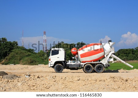 Heavy concrete truck on construction site against blue sky