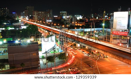 BANGKOK-JUL 06: Light trail on bridge at Rama 9 street on July 06, 2012 in Bangkok, Thailand. This bridge, located on Huay Kwang district, is set up to cross Rama IX junction and MCOT junction.