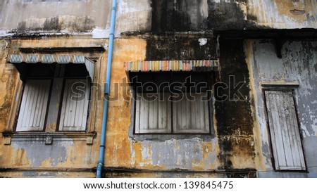 Awnings and wooden windows at grunge wall