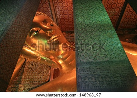 BANGKOK-DEC 09: Reclining large golden Buddha statue at the Wat Pho on December 09, 2011 in Bangkok,Thailand. The reclining Buddha (Phra Buddhasaiyas) is 15m high and 43m long.