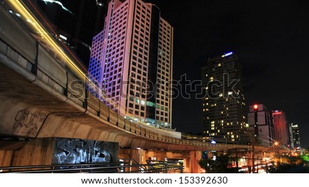 BANGKOK - JUL 07: Light trails on BTS elevated rail at Sathorn business center on July 07, 2012 in Bangkok, Thailand. Elevated rails cover business, resident, and tourist areas by 32 stations.
