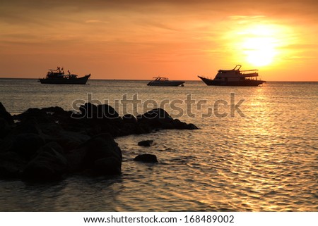sunset above the sea and cruise ships at Koh Lipe, Thailand