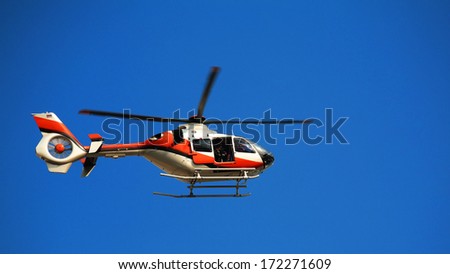 TV news helicopter with blur propeller at blue sky