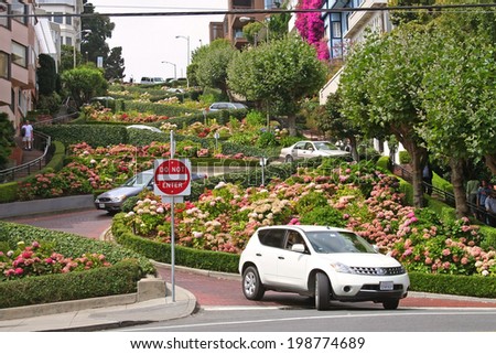 SAN FRANCISCO, USA - AUGUST 28, 2006: Many vehicles drive downhill on Lombard Street, one of the most famous landmark and the crookedest street in the world.