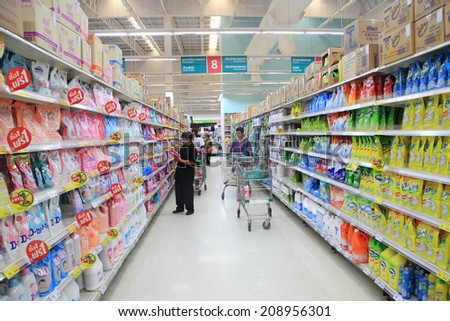 BANGKOK, THAILAND - AUGUST 02, 2014: Unidentified people seeking goods on Aisle at Tesco Lotus supermarket. Tesco is the world\'s second largest retailer with 6,531 stores worldwide.