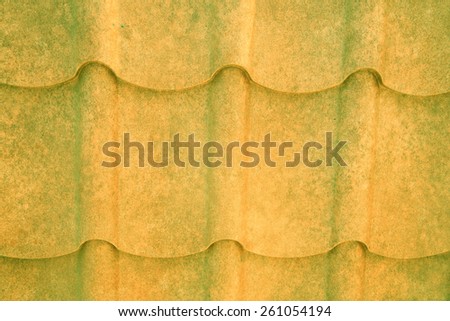 grained yellow and green metal roof. Textured background