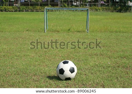 Background: Soccer ball and small goal on the field
