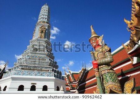 Ornament: red giant guardian and shrine architecture at Wat Phra Kaew in Bangkok, Thailand