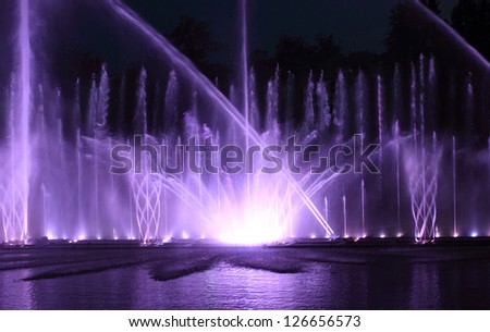 Color water fountain at night outdoor