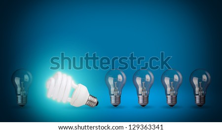 Row of light bulbs and energy save bulb. Idea concept on blue background.
