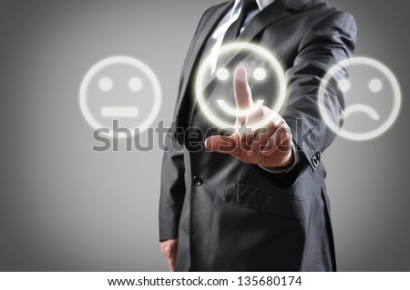 Businessman hand choosing smile on touch screen Businessman hand choosing smile on touch screen