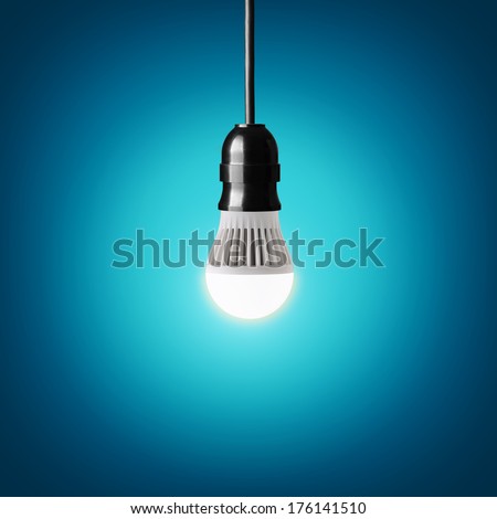 Glowing led bulb on blue background