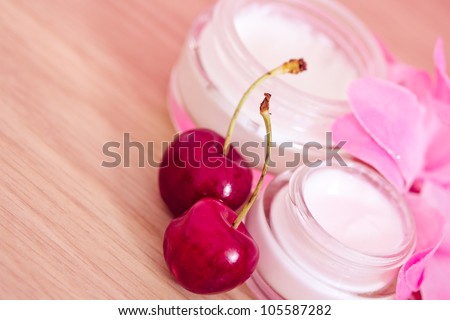 concept of organic cosmetics, lotions and cherries