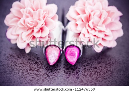 pink lipsticks and flower petals