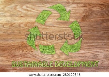 green economy and ecology: symbol of recycling made of grass with writing Sustainable development