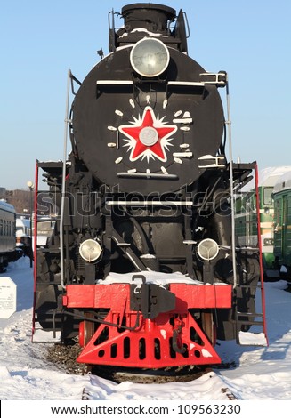 locomotive at a train station in winter,  front view