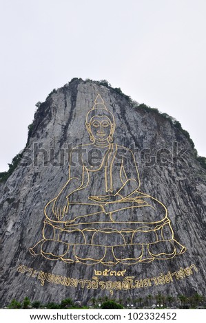 Golden Buddha painting on a cliff, Chee-Chan mountain, Thailand